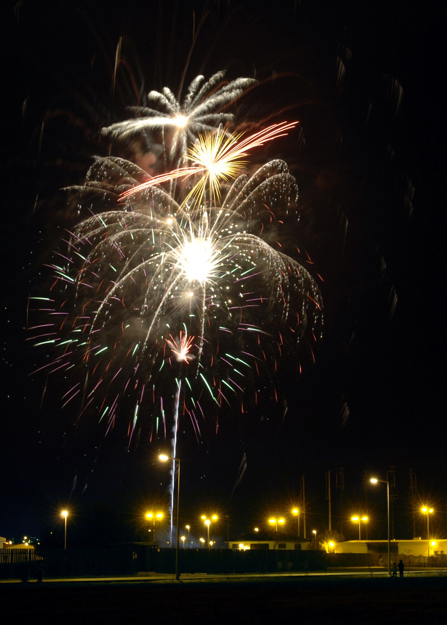 Fireworks burst over Patriot Village during the 4th of July celebration at Arkadas Park.  The festivities included fireworks, food and music by the Armed Forces Entertainment band Sole Funktion. (U. S. Air Force photo by Airman 1st Class Nathan W. Lipscomb)
