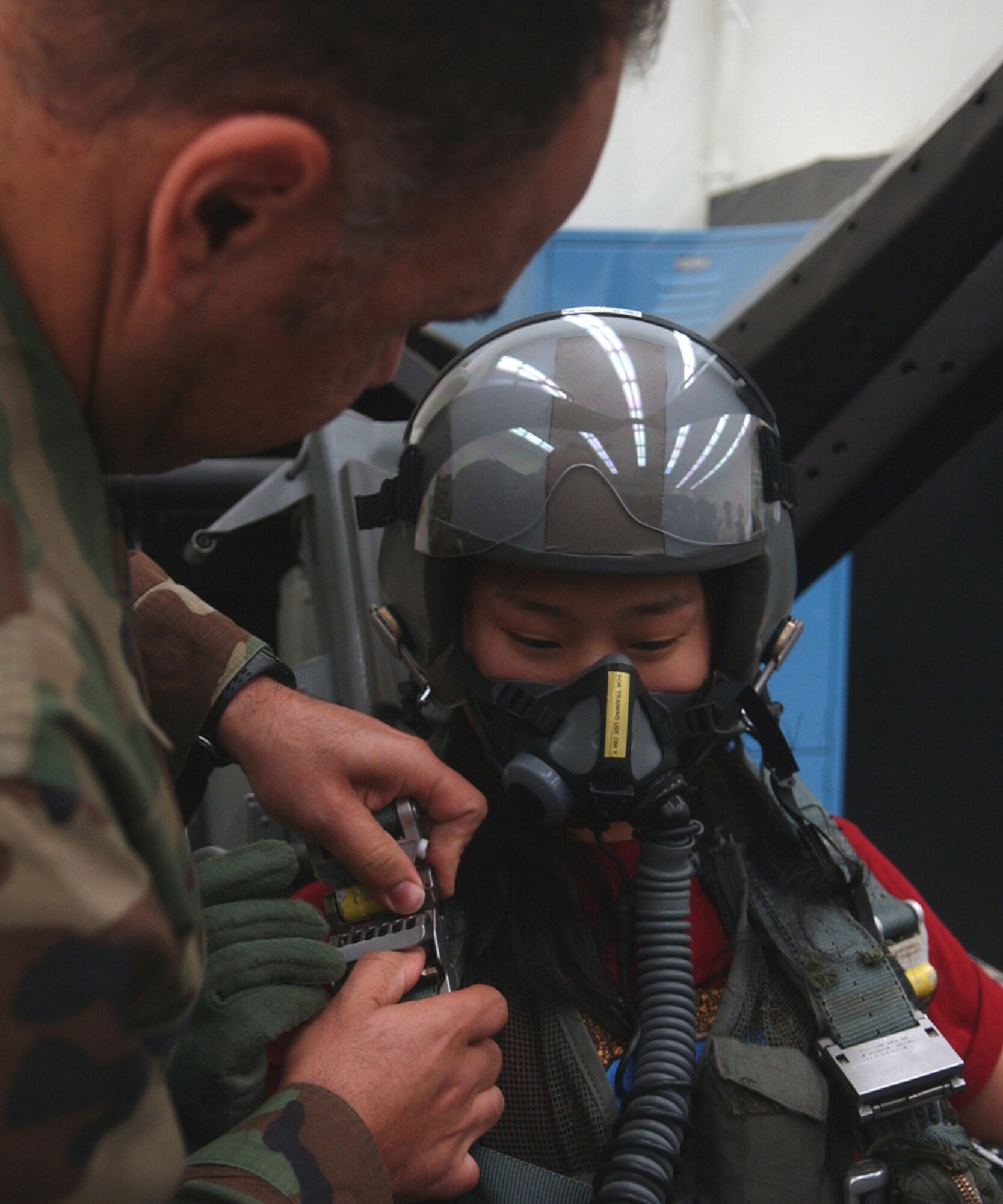 OSAN AB, Republic of Korea – Kim Eun-Jung, a student from the Far East University in Chungbuk, Republic of Korea, gets strapped into an egress training simulator on July 2, 2007.  The students from the Far East University were touring the base to learn about Osan’s mission and personnel, the trip also served as an English language immersion day.  (U.S. Air Force photo by Airman 1st Class Jason Epley)    