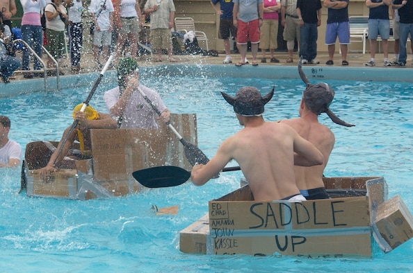 KUNSAN AIR BASE, Republic of Korea -- Senior Airman Peter Mellon and Army Staff Sgt. Thea Sm, American Forces Network-Kunsan (left) battle Airmen First Class Eddie Morell and Chad Hoing during the Fourth of July boat race here.  The base celebrated the U.S.'s 231st birthday.  Festivities included a watermelon-eating contest, float parade and fireworks show. Airmen Morell and Hoing are assigned to the 8th Maintenance Squadron. (U.S. Air Force photo/Staff Sgt. Darcie Ibidapo)