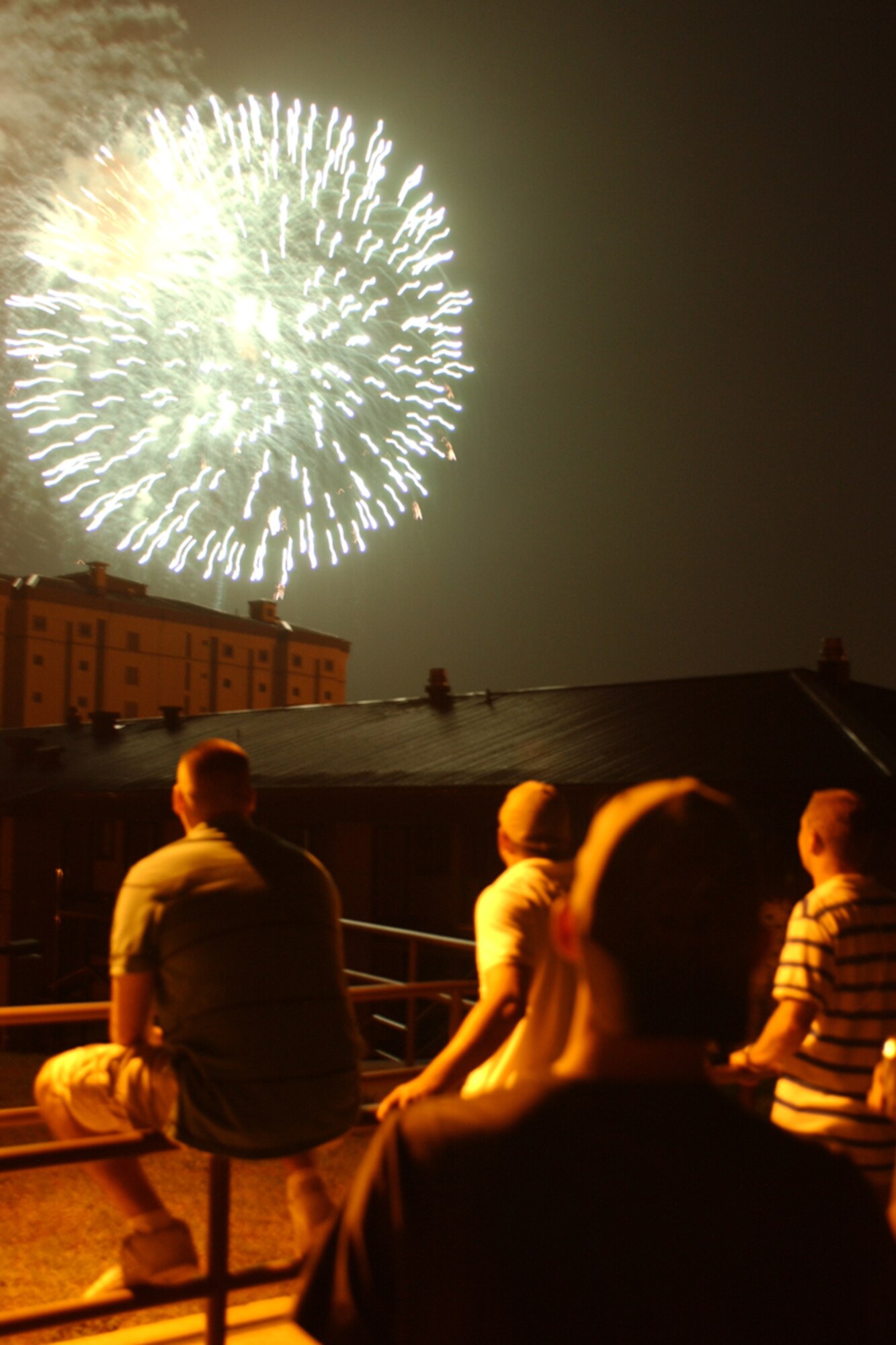 OSAN AIR BASE, Republic of Korea -- Members of Team Osan watch fireworks explode high overhead during the July 4th celebration Liberty Fest held on Osan.  Liberty Fest provided members of Team Osan a chance to celebrate the 4th with food and games, and culminated with the fireworks at the end of the night.  (U.S. Air Force photo by Airman Jason Epley)