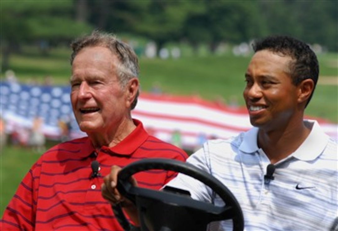 Tiger Woods gives former President George H.W. Bush a ride to the first tee during the inaugural Earl Woods Memorial Pro-Am at the Congressional Country Club in Bethesda, Md., July 4, 2007.