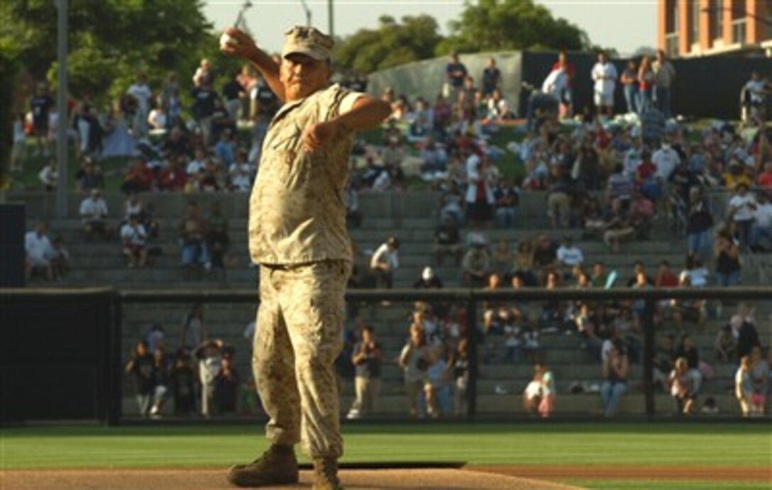 U.S. Navy Petty Officer 3rd Class Nathaniel R. Leoncio throws the opening pitch for the San Diego Padres and Florida Marlins game at PETCO Park in San Diego, July 4, 2007. The Navy corpsman suffered injuries while on patrol in Ramadi, Iraq, Oct. 4, 2005.