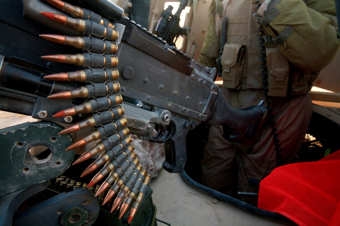 AL TAQADDUM, Iraq (July 7, 2007) ?  A gunner provides rear security for a security patrol here. As the insurgents try to thwart Iraq?s progress, it is the responsibility of the Marines with Military Police Company, 2nd Maintenance Battalion, 2nd Marine Logistics Group (Forward) to keep a watchful eye on the roads. At the ?tip of the spear? of the patrols are the patrol leaders mostly of whom are corporals: the junior noncommissioned officer rank in the Corps.