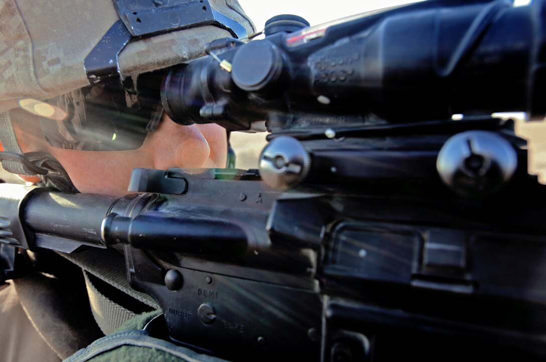 AL TAQADDUM, Iraq (July 7, 2007) ?  Cpl. Andrew B. Coleman looks down the scope of his rifle during a security patrol here. As the insurgents try to thwart Iraq?s progress, it is the responsibility of the Marines with Military Police Company, 2nd Maintenance Battalion, 2nd Marine Logistics Group (Forward) to keep a watchful eye on the roads. At the ?tip of the spear? of the patrols are the patrol leaders mostly of whom are corporals: the junior noncommissioned officer rank in the Corps.