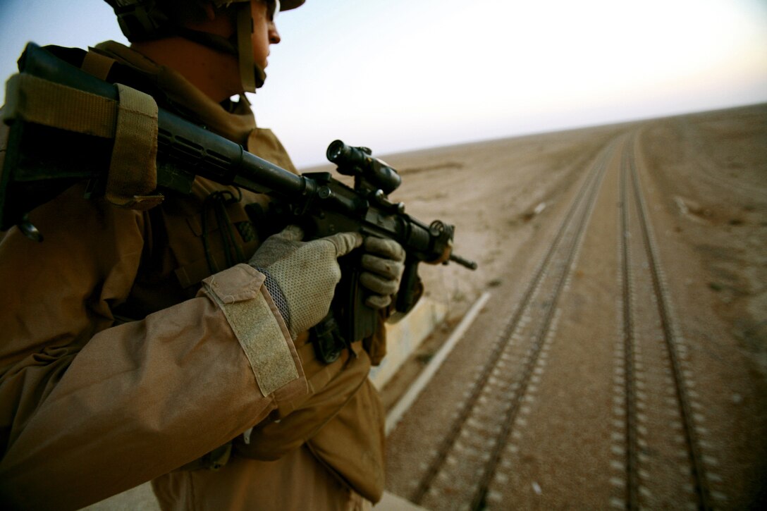 AL TAQADDUM, Iraq (July 7, 2007) ?  A Marine secures a set of railroad tracks during a security patrol here. As the insurgents try to thwart Iraq?s progress, it is the responsibility of the Marines with Military Police Company, 2nd Maintenance Battalion, 2nd Marine Logistics Group (Forward) to keep a watchful eye on the roads. At the ?tip of the spear? of the patrols are the patrol leaders who are mostly Corporals: the junior NCO rank in the Corps.