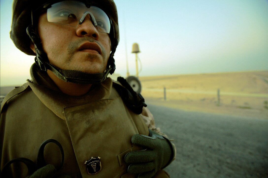 AL TAQADDUM, Iraq (July 7, 2007) ? A hospital corpsman watches his Marines secure a bridge during a security patrol here. As the insurgents try to thwart Iraq?s progress, it is the responsibility of the Marines with Military Police Company, 2nd Maintenance Battalion, 2nd Marine Logistics Group (Forward) to keep a watchful eye on the roads. At the ?tip of the spear? of the patrols are the patrol leaders mostly of whom are corporals: the junior noncommissioned officer rank in the Corps.