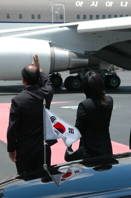Businessmen and civic leaders from the local Korean community waved as President Roh Moo-hyun and First Lady Kwon Yang-suk's plane departed Hickam Air Force Base today at noon.  