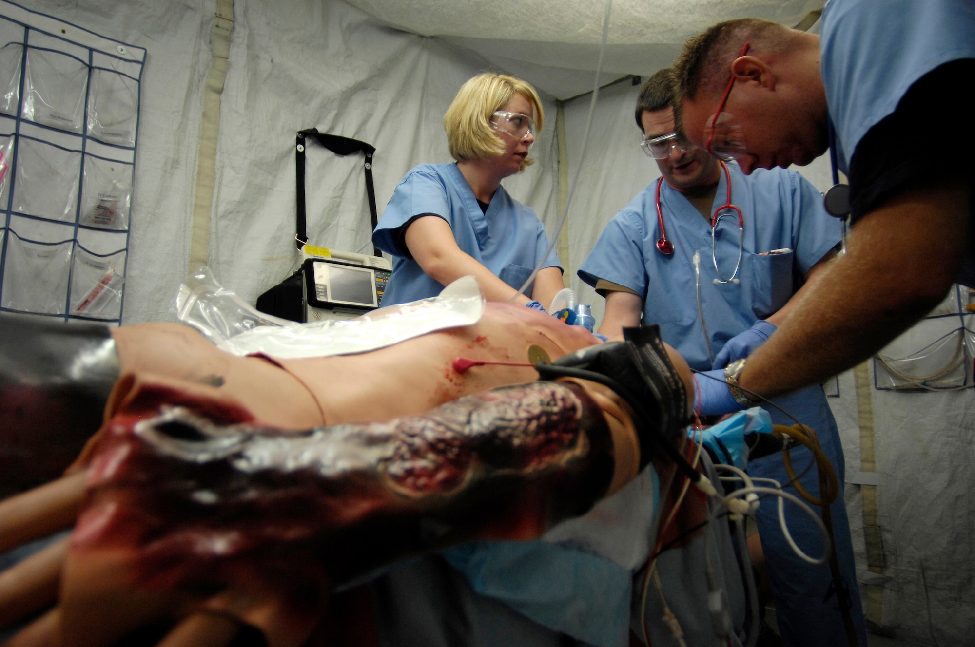 Staff Sgt. Rebecca Timms, Maj. David Olson and Capt. Jeremy Egly (left to right) work on a human patient simulator July 5 during a training scenario at the St. Louis University Hospital.  The Center for Sustainment of Trauma and Readiness Skills, or C-STARS, is a training program created for Air Force medical personnel that is integrated into major civilian trauma centers throughout the continental United States. Training with civilian counterparts provides real-life hands on trauma care experience for Air Force medical personnel. (U.S. Air Force photo/Staff Sgt. Brian Ferguson) 