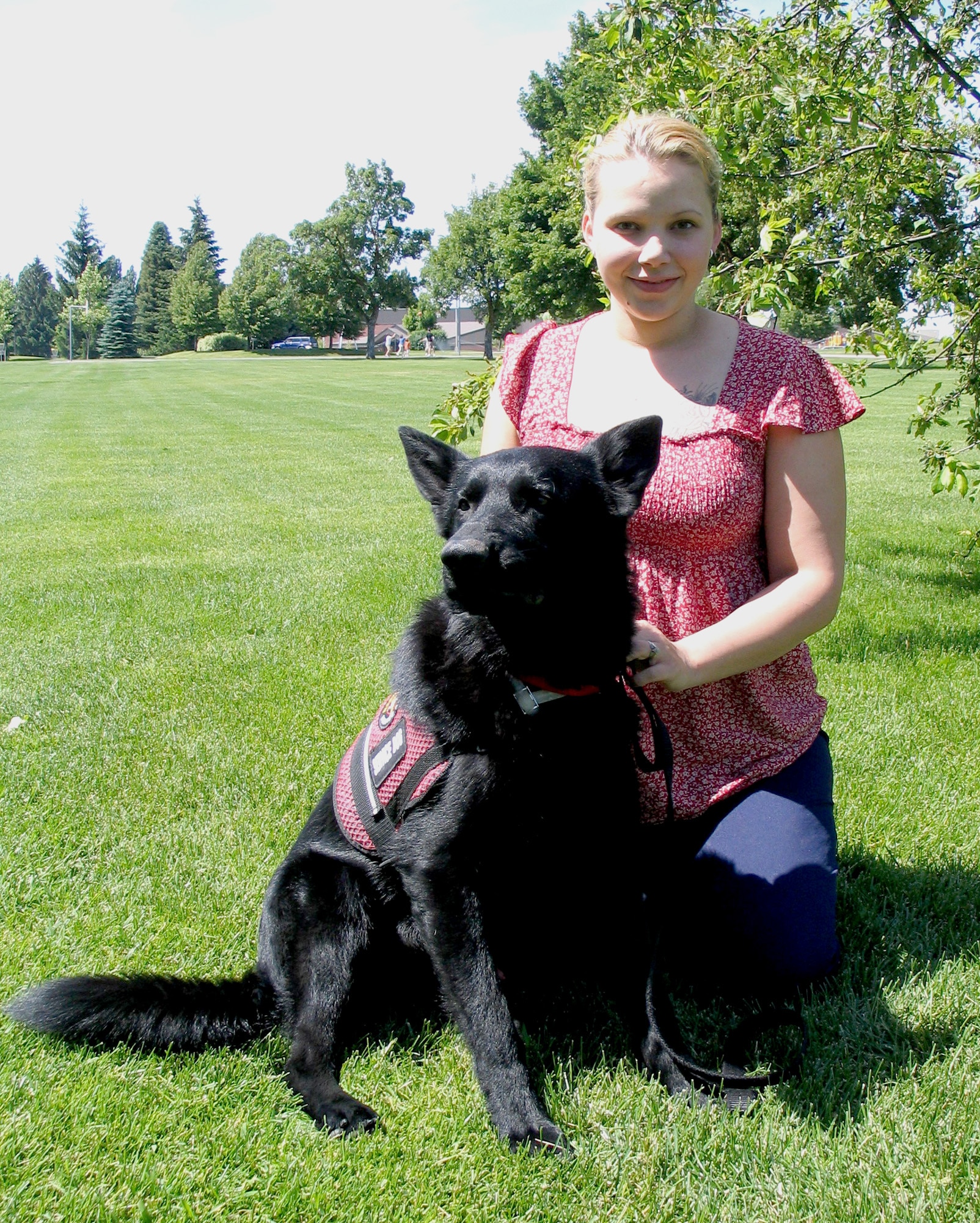 FAIRCHILD AIR FORCE BASE, Wash. – Kimberly Hawks kneels with her medical alert dog, Zeuss, an 18-month-old German Shepherd. Kimberly obtained Zeuss from a breeder in Seattle, Wash., after detailed research about medical dogs and their services. Zeuss comes from an accomplished canine family; his parents are both champion show dogs, and his brother is a drug detection dog in Arizona. (U.S. Air Force photo/ Staff Sgt. Connie L. Bias)