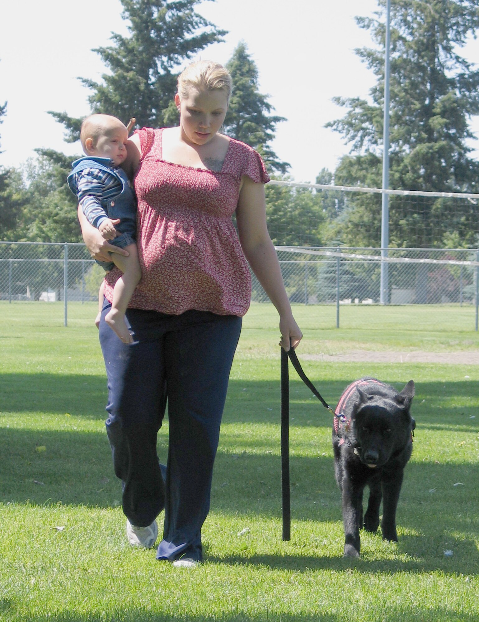 FAIRCHILD AIR FORCE BASE, Wash. – Kimberly Hawks walks with her son Jeremy, 14 months, and medical alert dog Zeuss at Miller Park here. Kimberly is married to Staff Sgt. Jeremy Hawks of the 92nd Civil Engineer Squadron explosive ordnance disposal unit, and they’re expecting their next child in August. Kimberly is in the process of training Zeuss for his medical alert duties, which include retrieving medications, waking Kimberly up and calling her attention to upcoming medical situations. (U.S. Air Force photo/ Staff Sgt. Connie L. Bias)