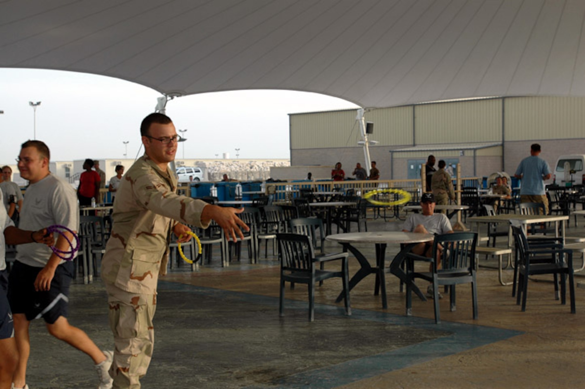 Airman 1st Class Jason Markley throws rings at a 4th of July celebration at a deployed location in Southwest Asia. Airman Markley is assigned to the 379th Expeditionary Contracting Squadron. (U.S. Air Force photo/Staff Sgt. Cassandra Locke)
