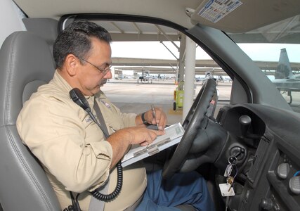 Larry Sanchez, T-38C Talon work leader and expeditor, reviews the daily flying schedule and ongoing maintenance log on the east flight line. (U.S. Air Force photo by Rich McFadden)