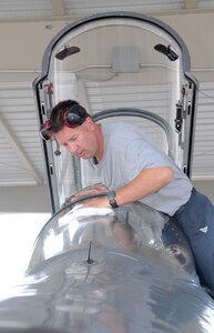 Scott Einfalt, east flight line crew chief, cleans the windshield of a T-38C Talon before its pilot shows up for his scheduled flight. (U.S. Air Force photo by Rich McFadden)