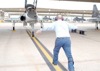 Tommy Richardson, east flight line crew chief, signals to a T-38C pilot that the aircraft’s ailerons are in working condition. (U.S. Air Force photo by Rich McFadden)