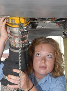 Crew chief Nicole Rodgers applies external air to a T-38C Talon on the east flightline for engine startup. Rodgers is one of 51 crew chiefs working on the base’s east flight line with the T-38 and T-1 fleets. (U.S. Air Force photo by Rich McFadden)