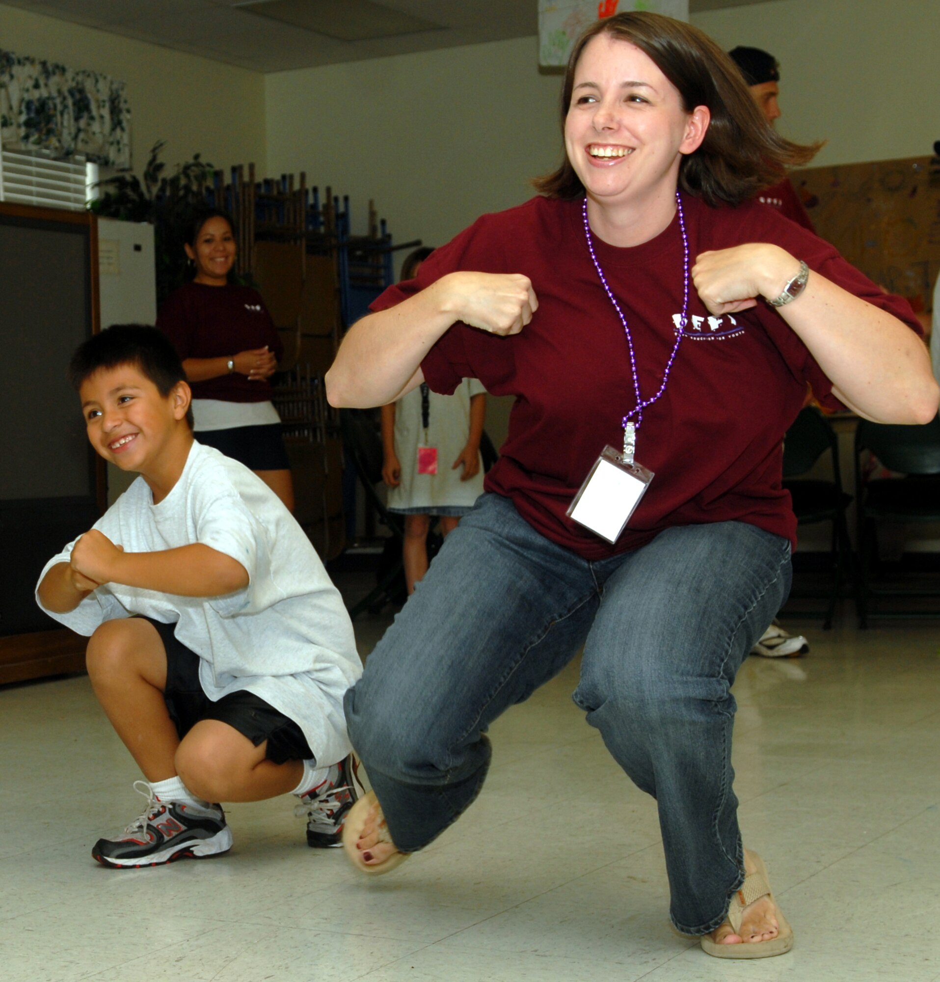 Matthew Dunn and Petty Officer 1st Class Carol Adsit work together to demonstrate the value of good communication during a DEFY activity. Petty Officer Adsit is a volunteer with the program. (U.S. Air Force Photo by Airman 1st Class Kamaile Chan)