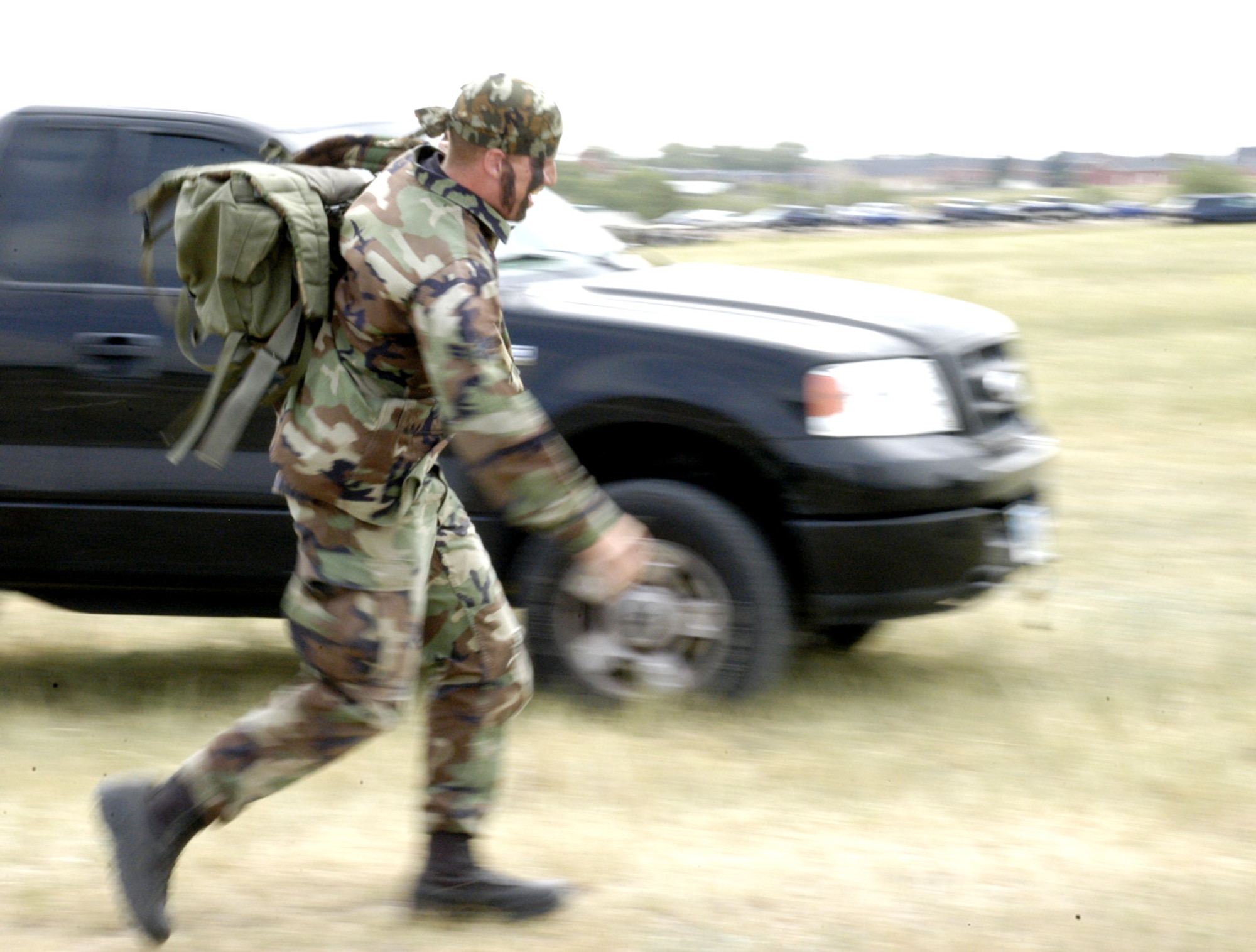 Airman 1st Class Bill Rhodes, 90th Security Forces Squadron, rushes toward the finish line with a sandbag-filled rucksack in an effort to beat the clock. This event tested the physical strength and agility the Airmen possess (Photo by Airman Alex Martinez).