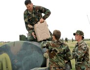 Staff Sgt. Eric Smith, 90th Missile Security Forces Squadron, empties the last 40-pound jug of water into the water buffalo in the water re-supply event. The Airmen had to fill up the jugs and run over to a supply container and top it off with water (Photo by Airman 1st Class Daryl Knee).

