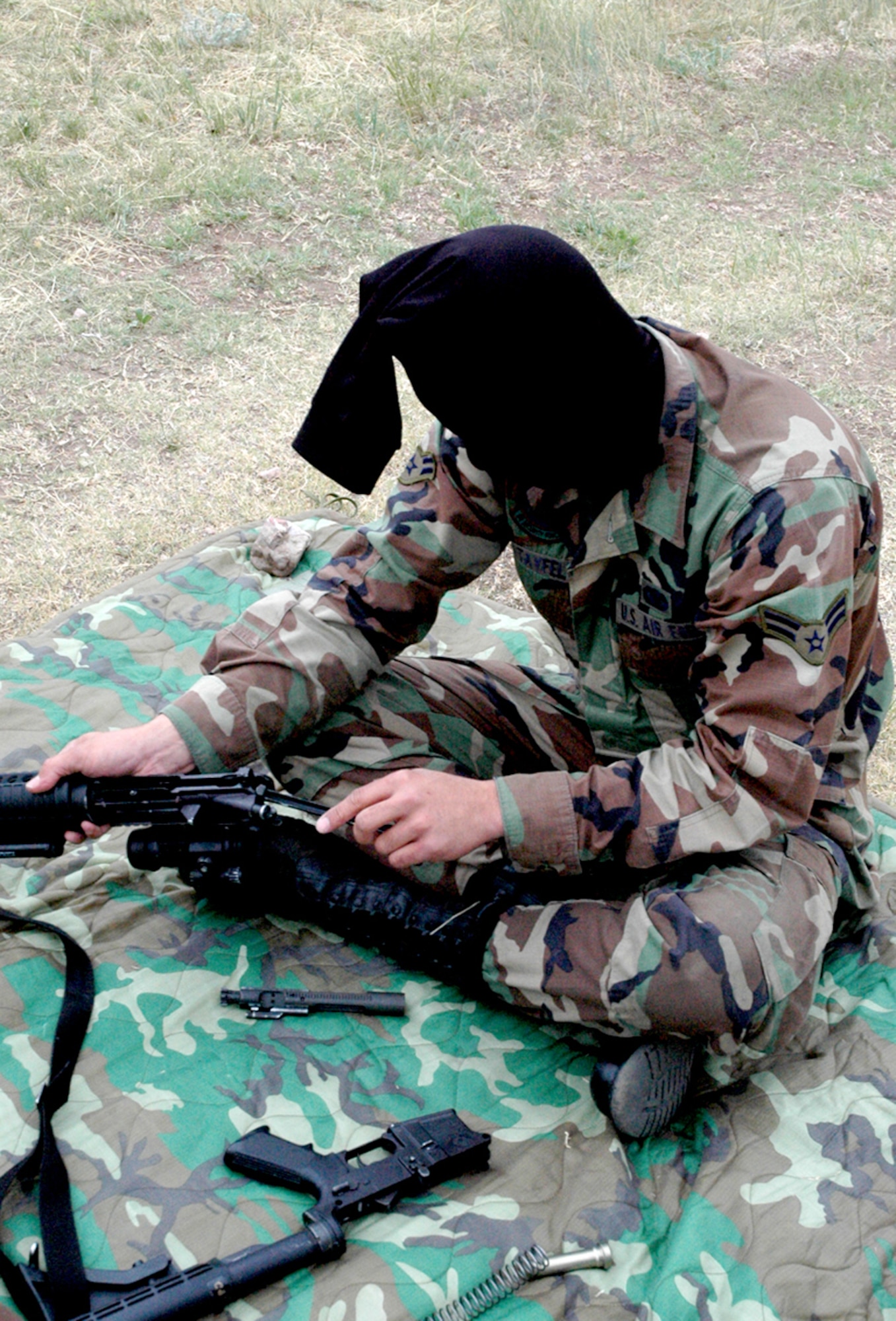 Airman 1st Class Steven Tayfel, 90th Security Forces Squadron, pieces together an M-4 rifle blindfolded. The score was determined by the time it took to successfully disassemble and reassemble the weapon (Photo by Airman 1st Class Daryl Knee).
