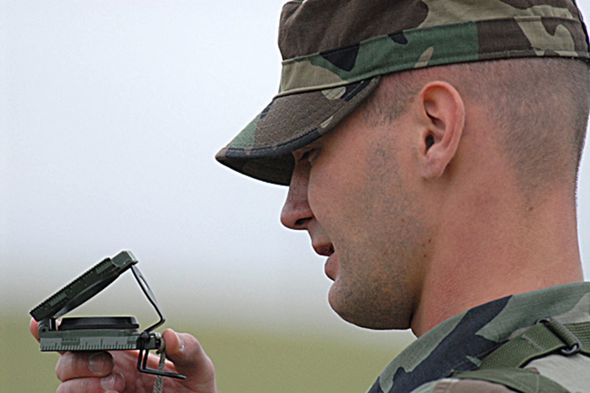 Airman 1st Class Joshua Smith, 790th MSFS response force flight 3, checks his compass during the navigation portion of the Crow Creek Challenge. Security forces were tested on a number of events throughout the day (Photo by Shelly Raffl).