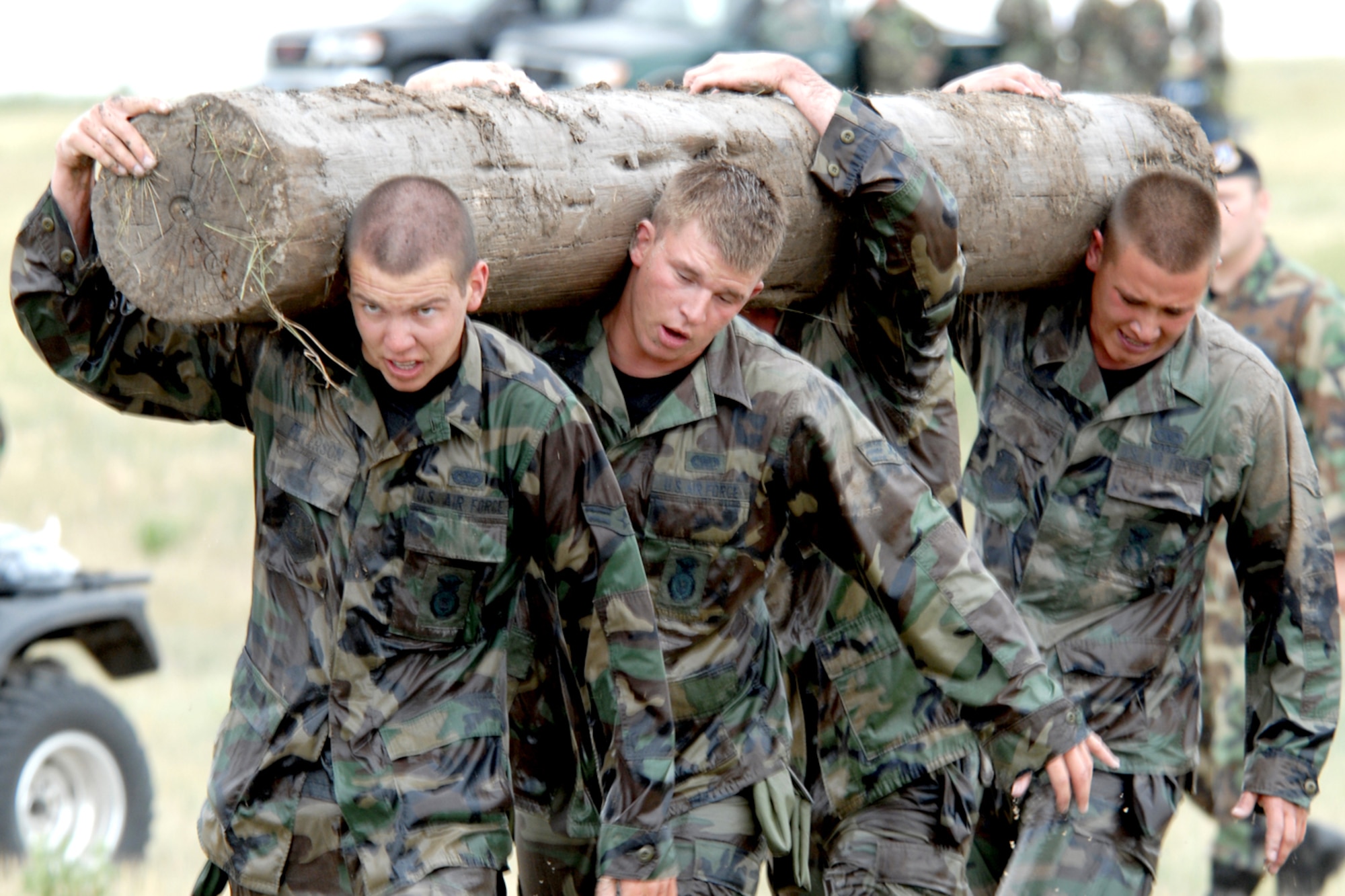 Airman 1st Class Thomas Peterson, Senior Airman Cliff Howie, Senior Airman Richie Phillips and Airman Ryan White, all of the 790th Missile Security Forces Squadron, carry a log during one of the “Team Pain” events (Photo by Shelley Raffl).
