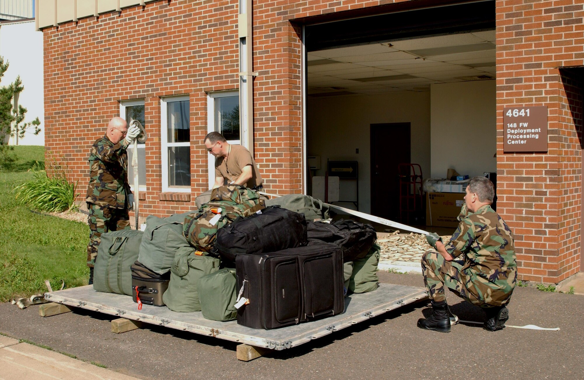 Members from the 148th Fighter Wing, Duluth, Minn., build a baggage pallet for a short-notice Air Sovereignty Alert deployment to Shaw Air Force Base, N.C.  (USAF Photo/Technical Sgt. Jason Rolfe)