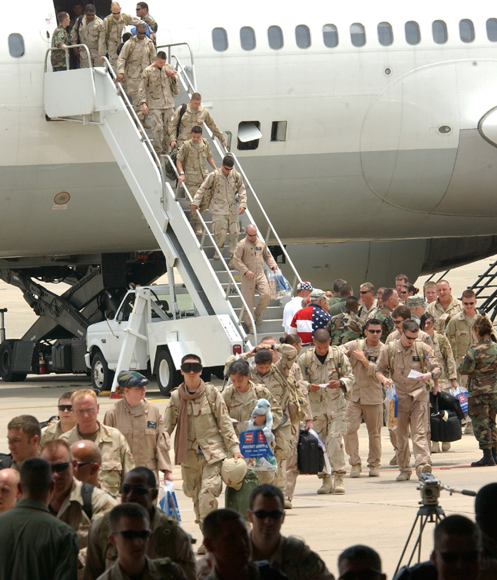Airmen returning home to Hurlburt Field, Fla., step off their plane toward the arms of the loved ones they have not seen for months while they were deployed to Iraq and Afghanistan. More than 200 Airmen returned home July 4. (U.S. Air Force photo/Tech. Sgt. Angela Shepherd)