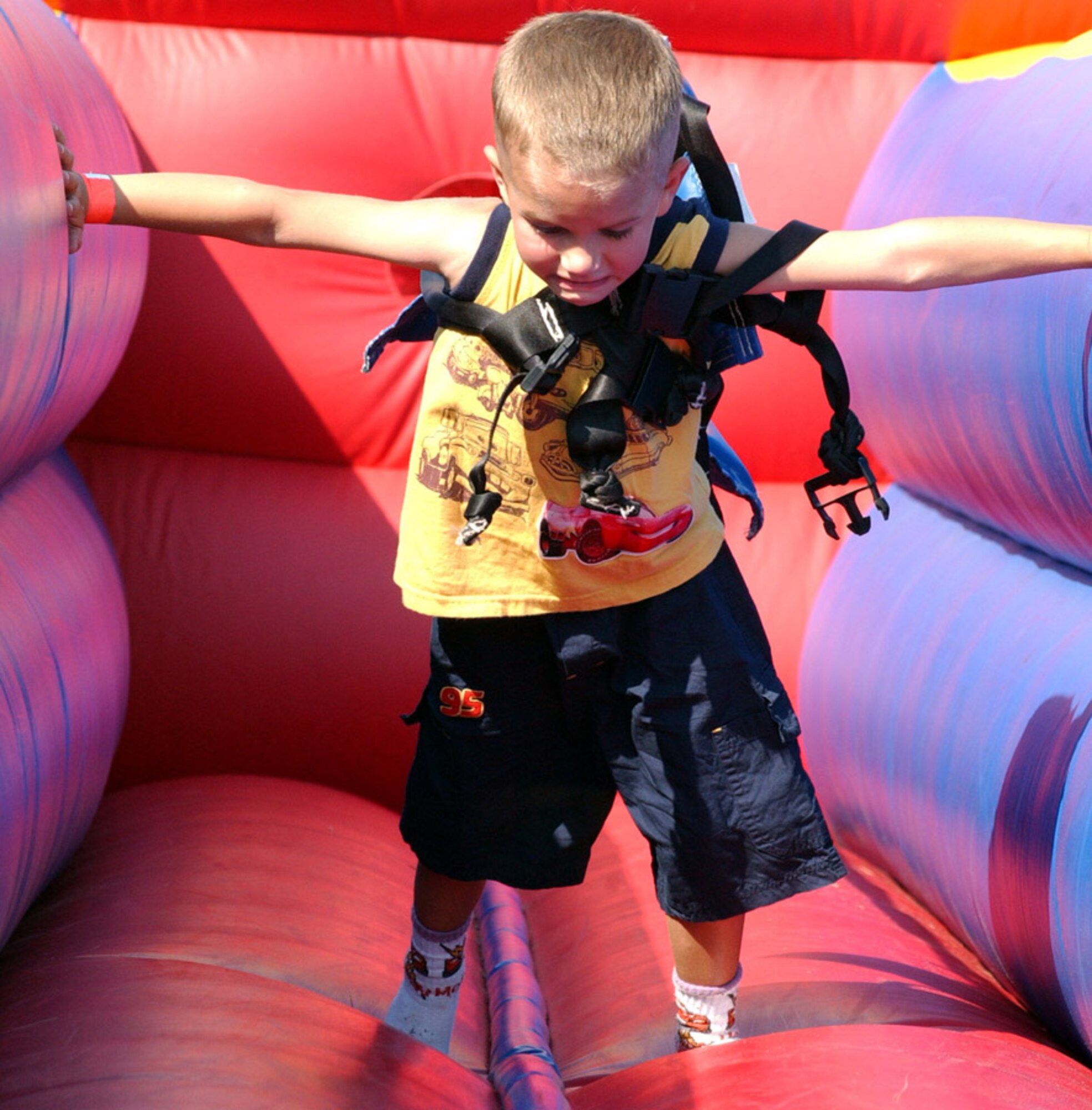 A little one tries with all his might to make some progress on this ride in the children's activity area at the 29th Annual Sound of Independence at the marina June 29. (U.S. Air Force photo/Tech. Sgt. Angela Shepherd)