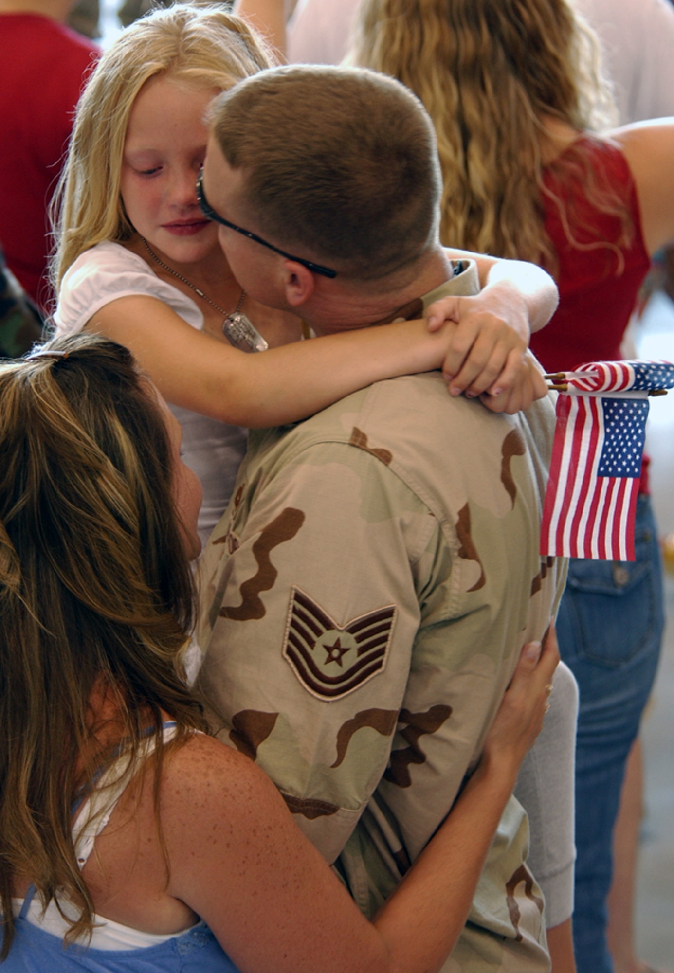 Tech. Sgt. Alan Finck comforts his daughter after returning from his deployment July 4 to Hurlburt Field, Fla. He was one of the more than 200 Airmen who returned from deployments in support of Operations Iraqi and Enduring Freedom on Independence Day. Sergeant Finck is assigned to the 1st Special Operations Equipment Maintenance Squadron. (U.S. Air Force photo/Tech. Sgt. Angela Shepherd)