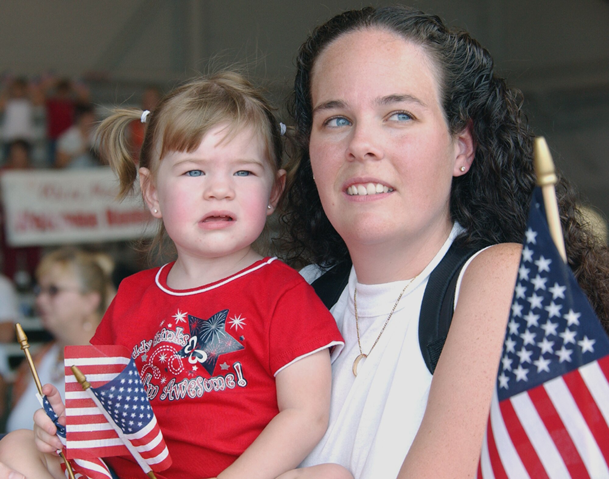 Melanie Mercer and her daughter, 19-month-old Kaylee, scan the sea of tan uniforms trying to catch the first glimpse of Tech. Sgt. Matthew Mercer returning home July 4 to Hurlburt Field, Fla. More than 200 Airmen returned from deployments in support of Operations Iraqi and Enduring Freedom on Independence Day. Sergeant Mercer is from the 1st Special Operations Aircraft Maintenance Squadron. (U.S. Air Force photo/Tech. Sgt. Angela Shepherd) 