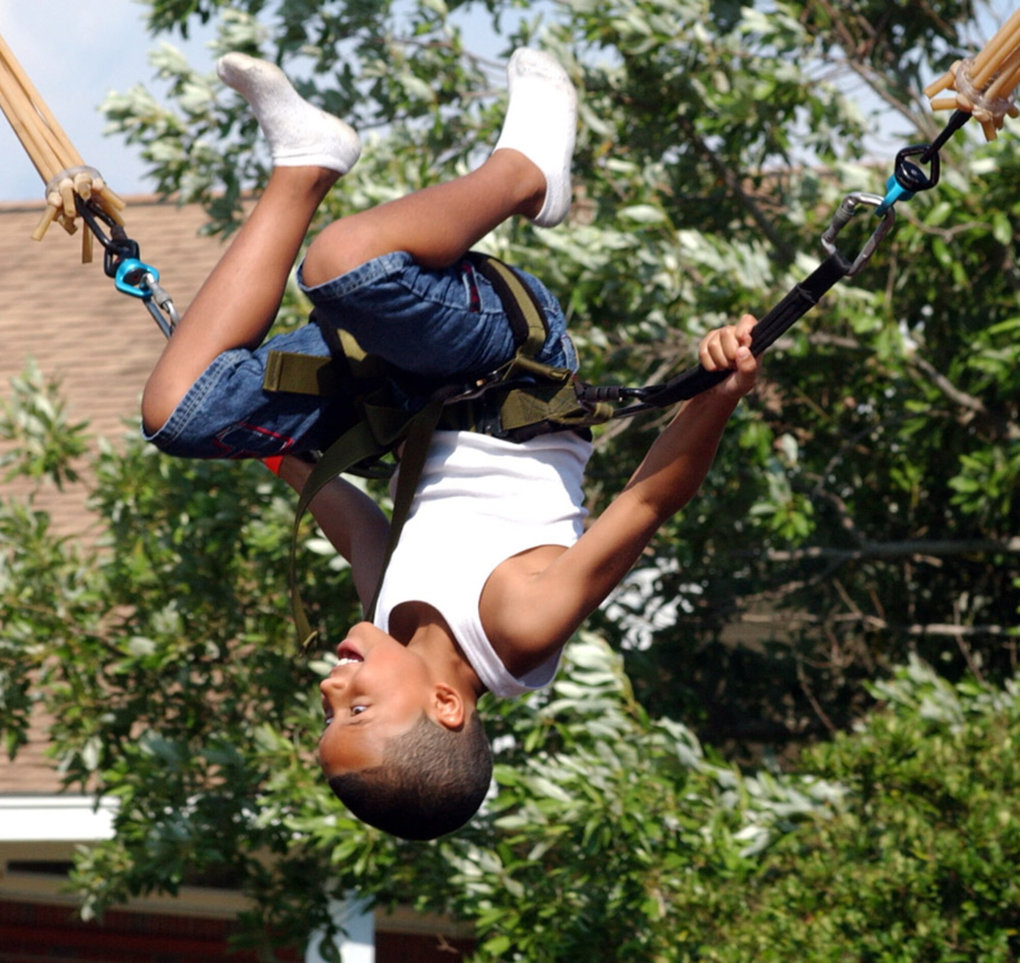 A child enjoys a little upside-down time on the trampoline in the children's activity area at the 29th Annual Sound of Independence at the marina June 29. (U.S. Air Force photo/Tech. Sgt. Angela Shepherd)