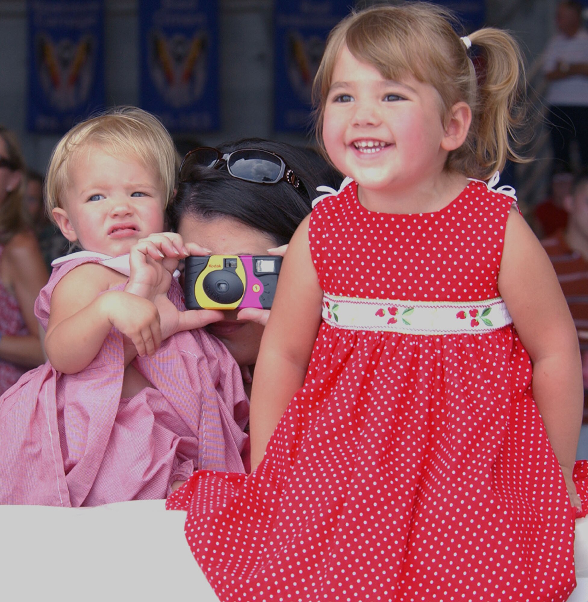 Two-year-old Sady Fells watches excitedly as the plane carrying her father, Senior Airman Skip Fells, rolls in July 4 at Hurlburt Field, Fla. Her 18-month-old sister, Emily, also looks on as mom Monica Fells takes a picture of the moment. More than 200 Hurlburt Field Airmen enjoyed the Fourth of July as they were reunited with their loved ones after deployments to Iraq and Afghanistan. Airman Fells is from the 20th Special Operations Squadron. (U.S. Air Force photo/Tech. Sgt. Angela Shepherd) 