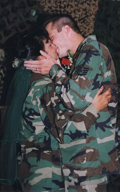 Senior Airman Ramona and Staff Sgt. Jeremy Curry kiss during their combat wedding held in the 66th Security Forces Squadron building on Aug. 21, 1998. The wedding is believed by the couple to be the first and only of its type to be held at Hanscom. The event was covered in the Aug. 28, 1998 edition of the Hansconian. The Currys plan to have a traditional wedding for their 10th anniversary on Aug. 21, 2008. (U.S. Air Force stock photo)