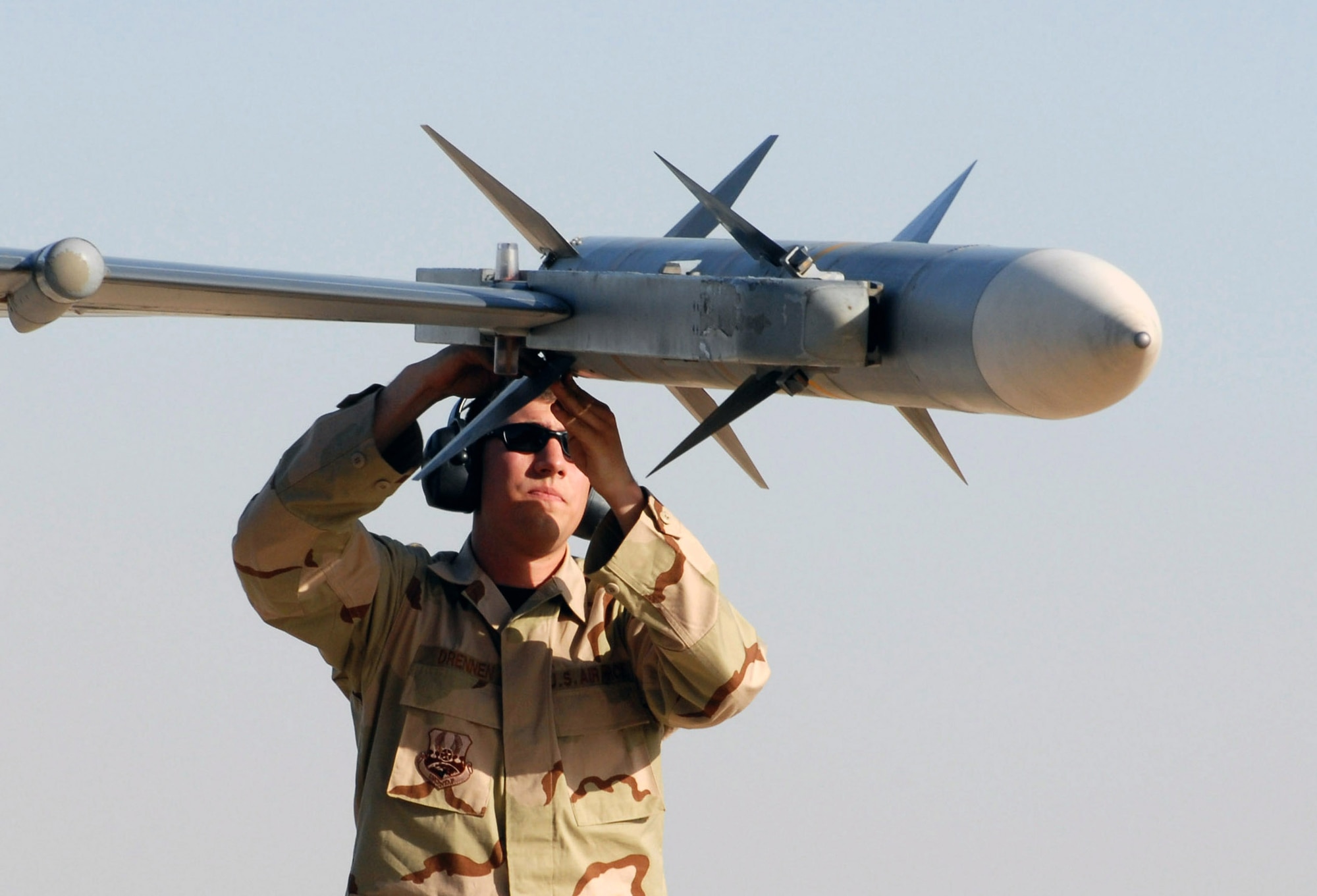 Airman 1st Class Mark Drennen checks an AIM-120 missile on an F-16 Fighting Falcon June 27 at Balad Air Base, Iraq, before a combat mission.  Airman Drennen is a weapons loader with the 332nd Expeditionary Aircraft Maintenance Squadron and deployed from Misawa Air Base, Japan. (U.S. Air Force photo/1st Lt. Shannon Collins)  