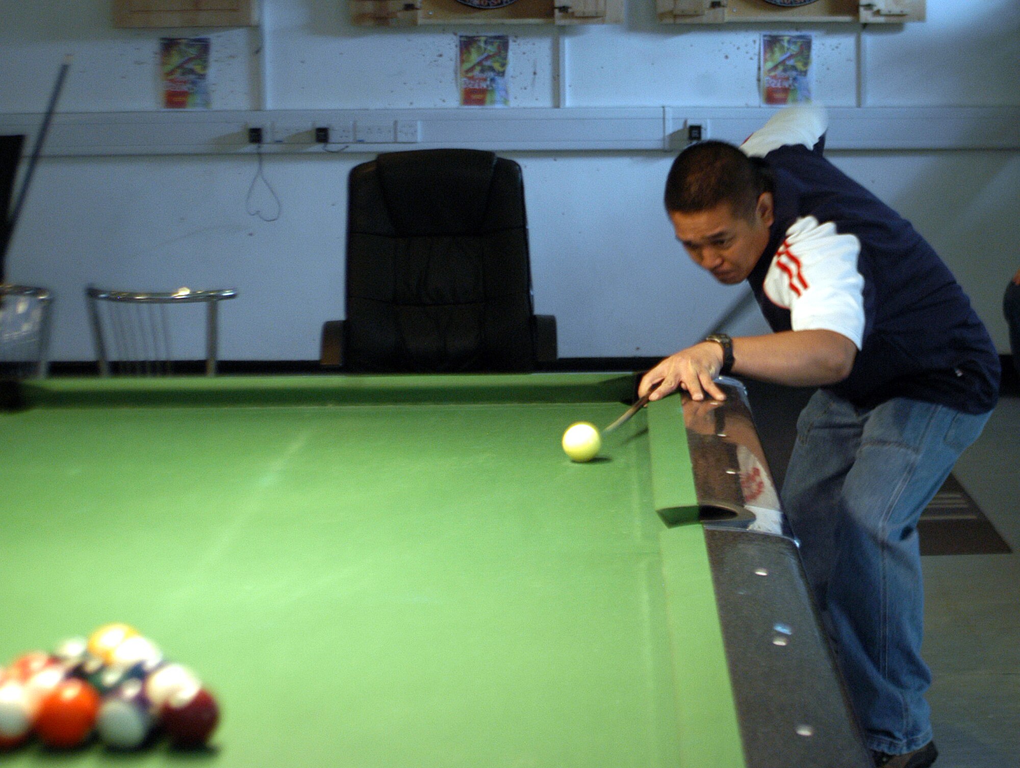 Frederick Polidario lines up the first break of the day during the Extreme Summer Poolshark Tournament at 48th Avenue July 1. The tournament involved six players and more than 40 matches to determine the Extreme Summer poolshark tournament champion. (U.S. Air Force photo by Airman 1st Class Kristopher Levasseur)

