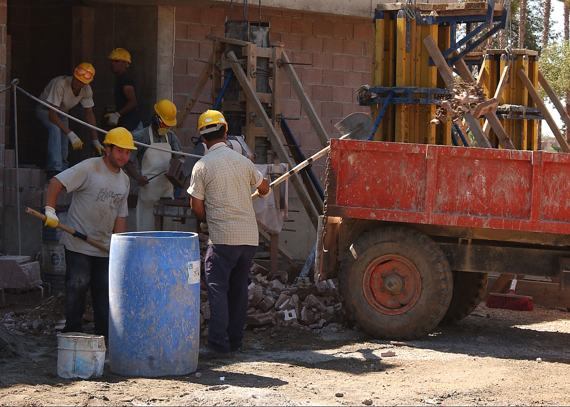 Construction workers from the Turkish company Makyal-Erka are working in the Eagle Housing project clearing debris from the worksite on June 21. (U. S. Air Force photo by Tech Sgt. Patrick Hyde

