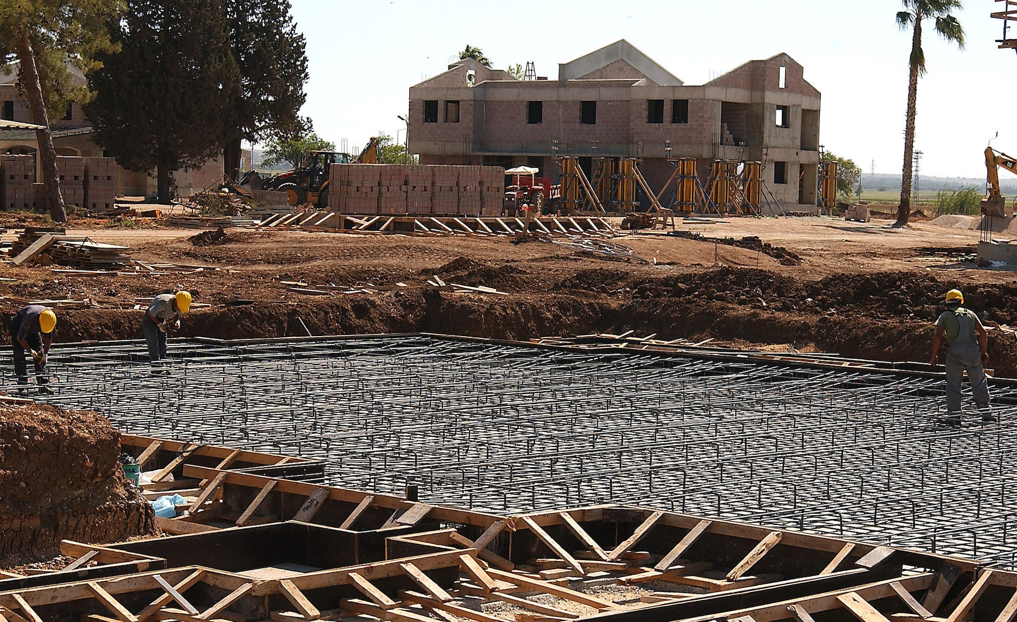 Turkish construction workers from the company Makyal-Erka help lay thousands of pounds of rebar steel re-enforced metal to create the foundations of the future Eagle Housing units. (U. S. Air Force photo by Tech. Sgt. Patrick Hyde)                         
