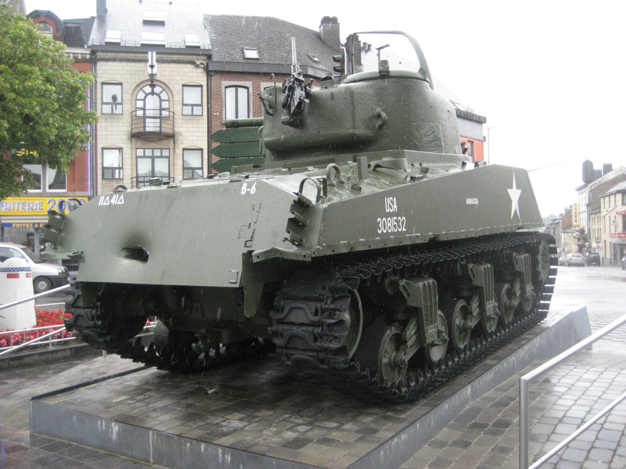 SPANGDAHLEM AIR BASE GERMANY -- A Sherman Tank called "Barracuda" from Company B, 41st Tank Battalion, 11th Armored Division, stands guard over MacAuliffe Place in Bastogne, Belgium. Several people from Spangdahlem AB visited the site during a trip sponsored by the European Military History Group July 5, 2007. (U.S. Air Force photo/Staff Sgt. Andrea Knudson)