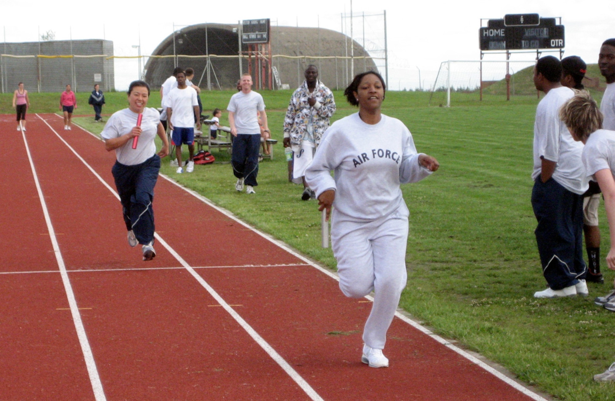 SPANGDAHLEM AIR BASE GERMANY -- During the 52nd Fighter Wing’s Sports Day July 2, 2007, 2nd Lt. Marsha Vaughans, 52nd FW protocol office, right, crosses the finish line seconds ahead of 2nd Lt. Susan Wong-Tworek, 52nd Communications Squadron, to seal first place for the 52nd Mission Support Squadron team for the 400-meter relay race. The 52nd CS’s team came in first place overall for sports day. (U.S. Air Force photo/Staff Sgt. Andrea Knudson)