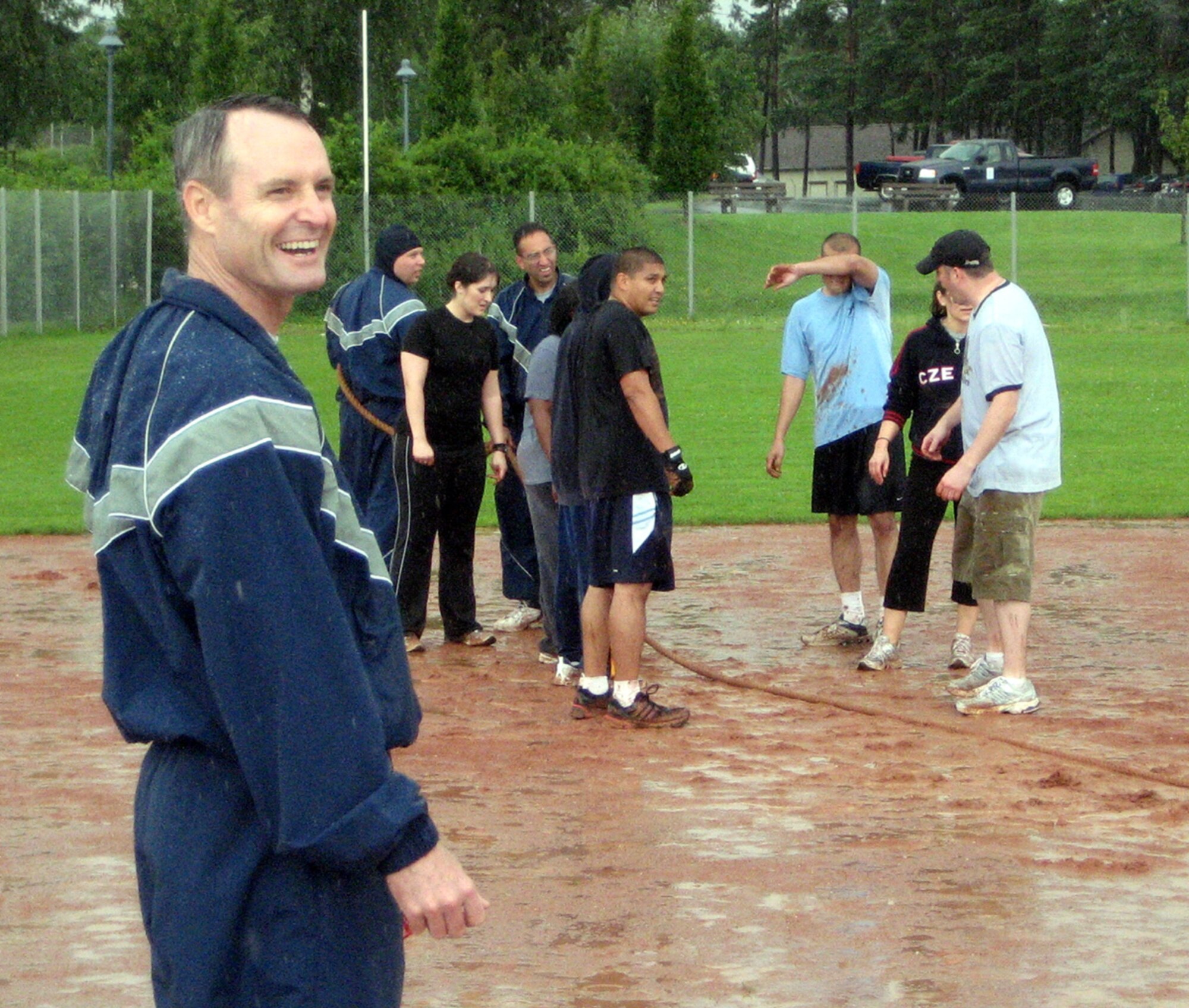 SPANGDAHLEM AIR BASE GERMANY -- Col. Darryl Roberson, 52nd Fighter Wing commander, enjoys the rain along with several Airmen participating in tug-of-war during the 52nd FW's Sport Day July 2, 2007. (U.S. Air Force photo)