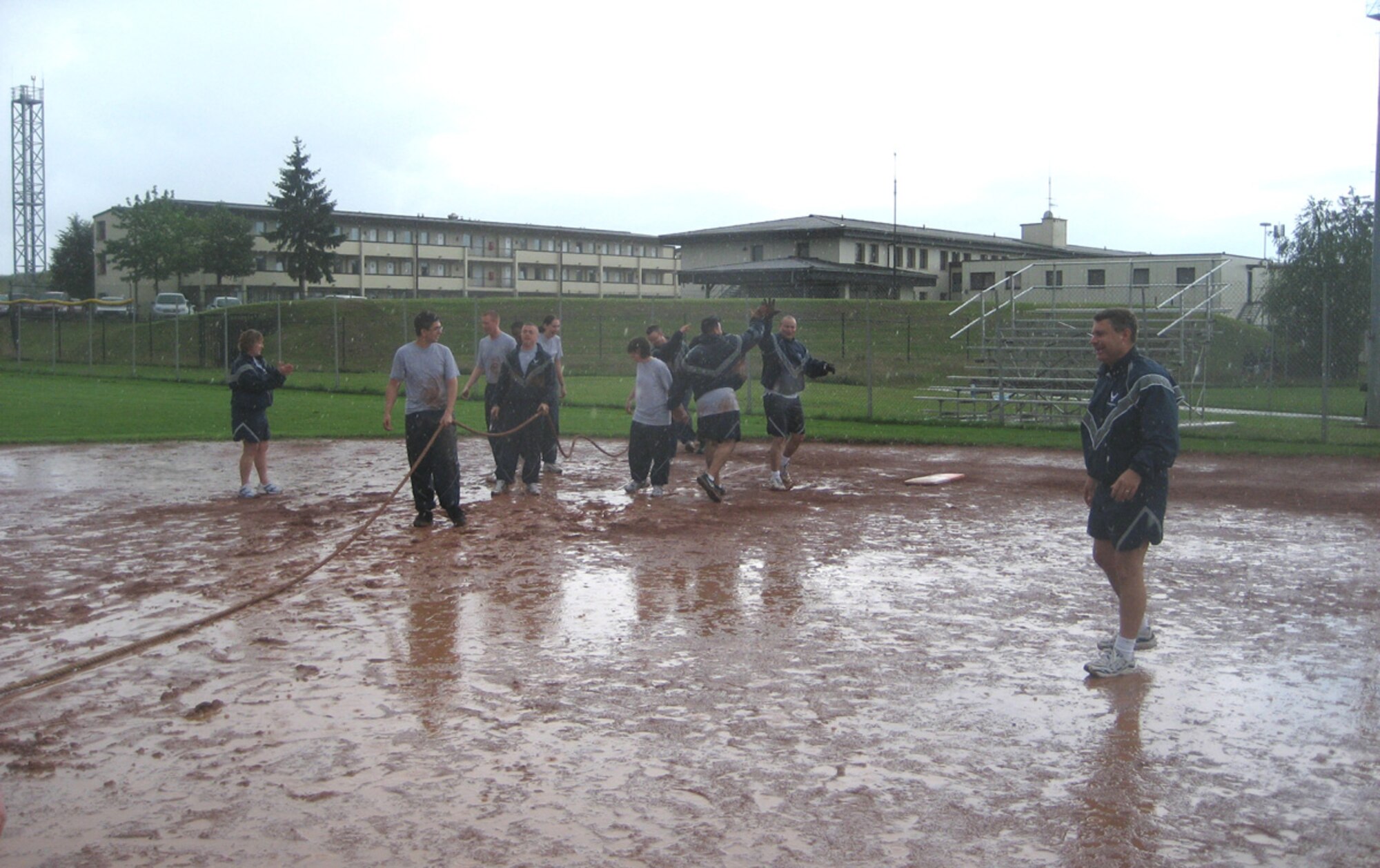 SPANGDAHLEM AIR BASE, Germany – Despite the rain and mud Airmen from the 52nd Fighter Wing prepare to begin tug-of-war during the 52nd FW's Sport Day as Col. Lt. Kevin Benneet, 52nd Communications Squadron commander looks on July 2, 2007. The 52nd CS team was the overall winner for Sports Day. (U.S. Air Force photo)