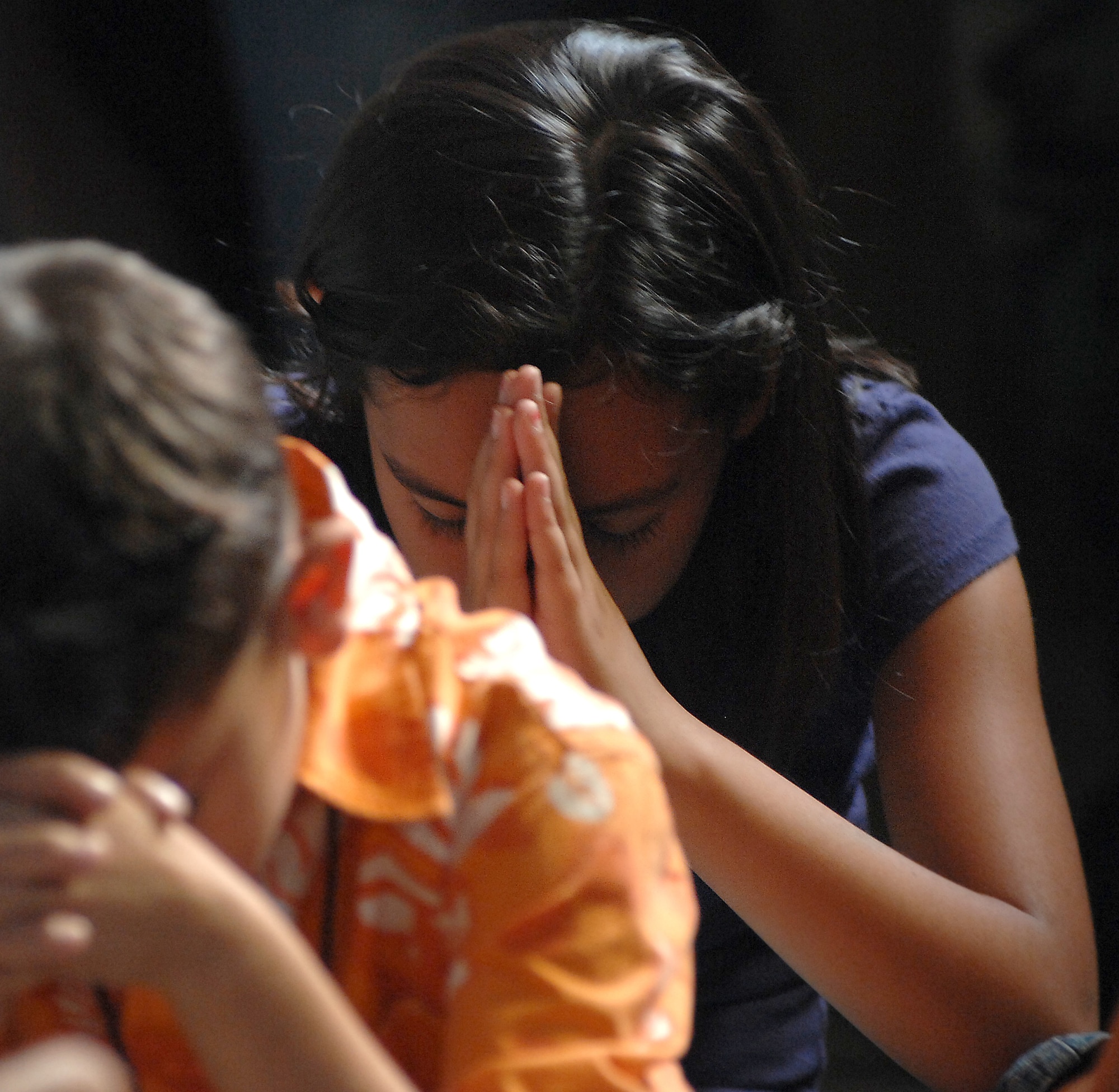 Alexandro Jasso, front, and Isabelle Calderon pray during Vacation Bible School. Activities included arts and crafts, music, games, bible study, science and worship.
(U.S. Air Force photo by Airman 1st Class Nathan Doza)