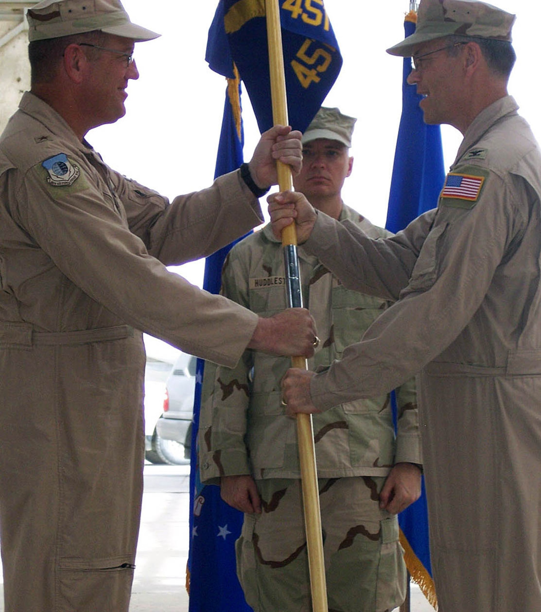 Col. Max Della Pia (right) accepts the 451st Air Expeditionary Group guidon from Brig. Gen. Bill Hyatt, 455th Air Expeditionary Wing commander, signifying the change in command for the group. In addition to the group command, Col. Della Pia also assumed the duties of senior airfield authority. (U.S. Air Force photo by Staff Sgt. Jonathan Dennis)