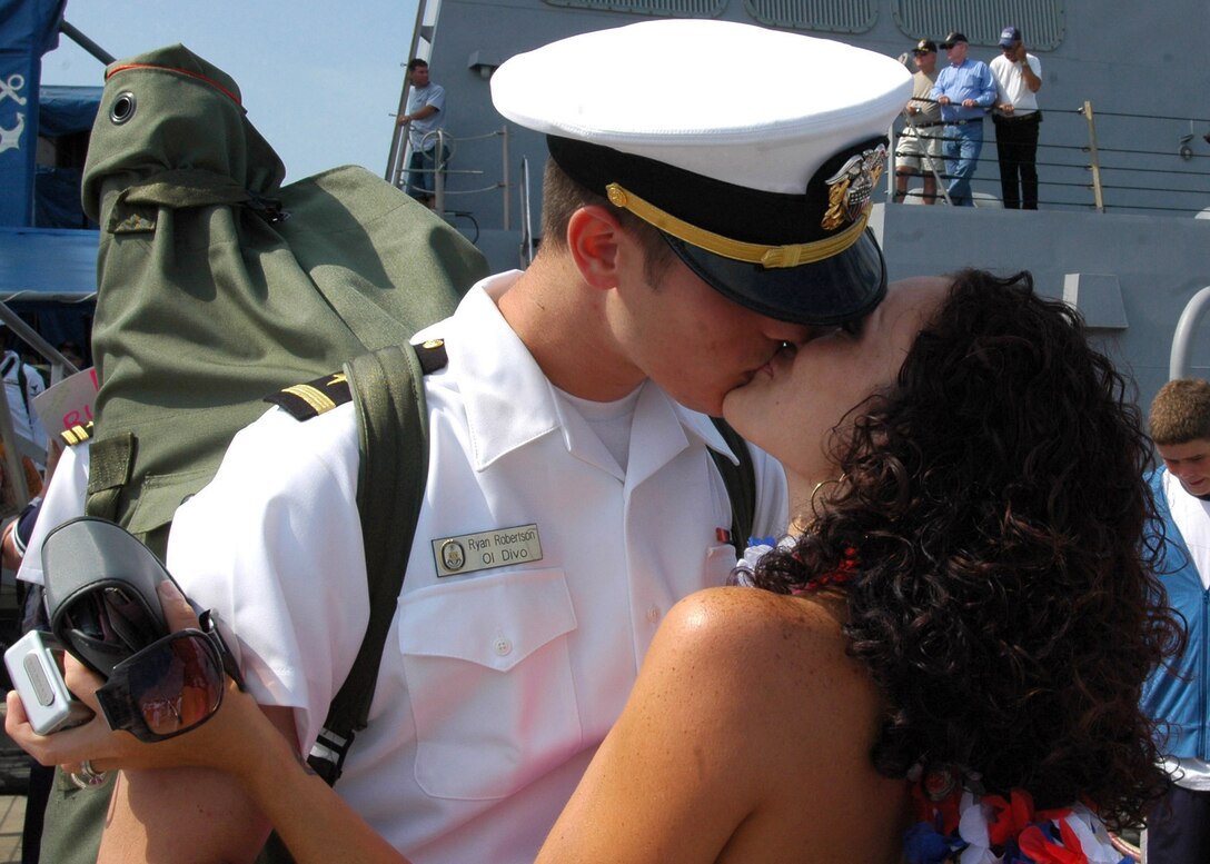 Ensign Ryan Robertson kisses his wife at Naval Station Norfolk, Va., July 3, 2007. The USS Nitze returned from a six-month deployment with Bataan Expeditionary Strike Group, which  supported maritime operations and theater security cooperation efforts in the 5th and 6th Fleet areas of operation. 