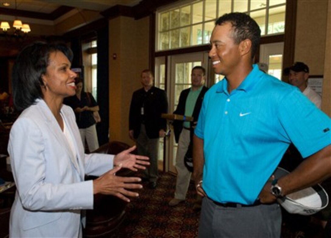 Tiger Woods, host of the AT&T National golf tournament, talks with novice golfer and Secretary of State Condoleezza Rice at the Congressional Country Club, Bethesda, Md., July 6, 2007.
