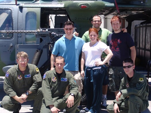 Tech. Sgt. Dustin Thomas, arial gunner; Airman 1st Class Michael Price, flight engineer; and Senior Airman Timothy Philpott, flight engineer, all from the 33rd Rescue Squadron at Kadena Air Base, Japan; pose with the band Blue Jupiter during a tour of the squadron July 3. The band suited up in aircrew life support gear, toured the weapons storage area and got a first hand look at the HH-60G Pavehawk Helicopter. 
                            