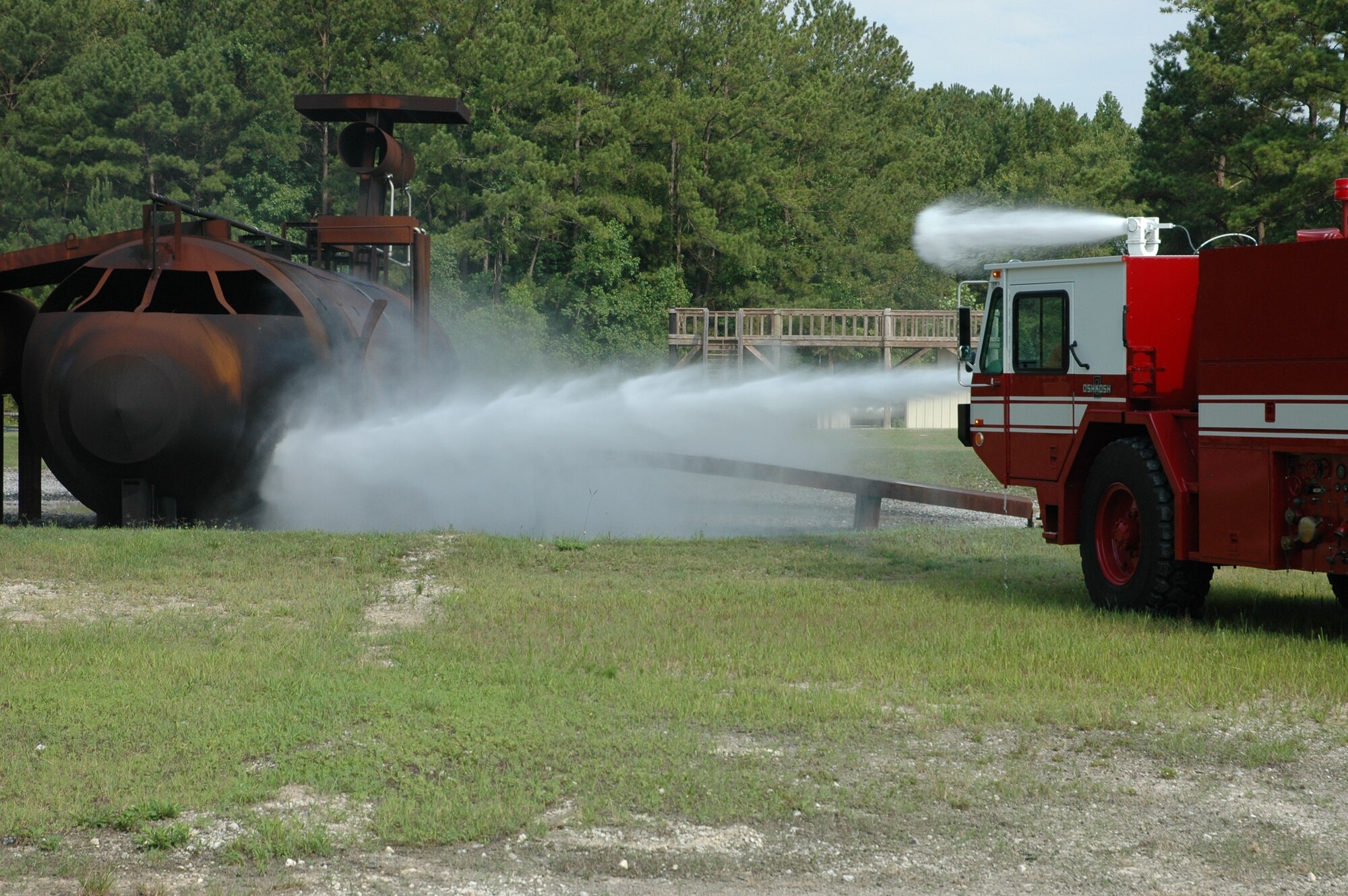 Members of Charleston Air Force Base Fire Department get vital training “in the seat” during a simulated crash made more realistic with real fire.  (Photo by Maj. Bill Walsh, USAFR)