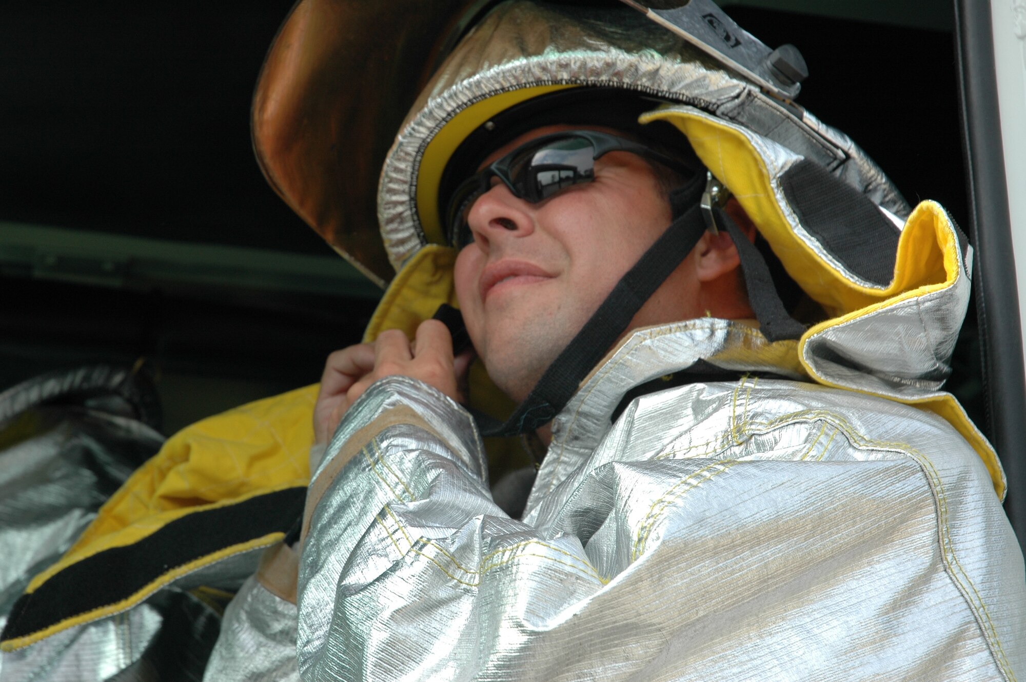 Senior Airman Chris Weakly, a reservist with the 315th CES Charleston AFB, S.C., checks his safety equipment before heading into a simulated aircraft crash complete with real fire.  (Photo by Maj. Bill Walsh, USAFR)