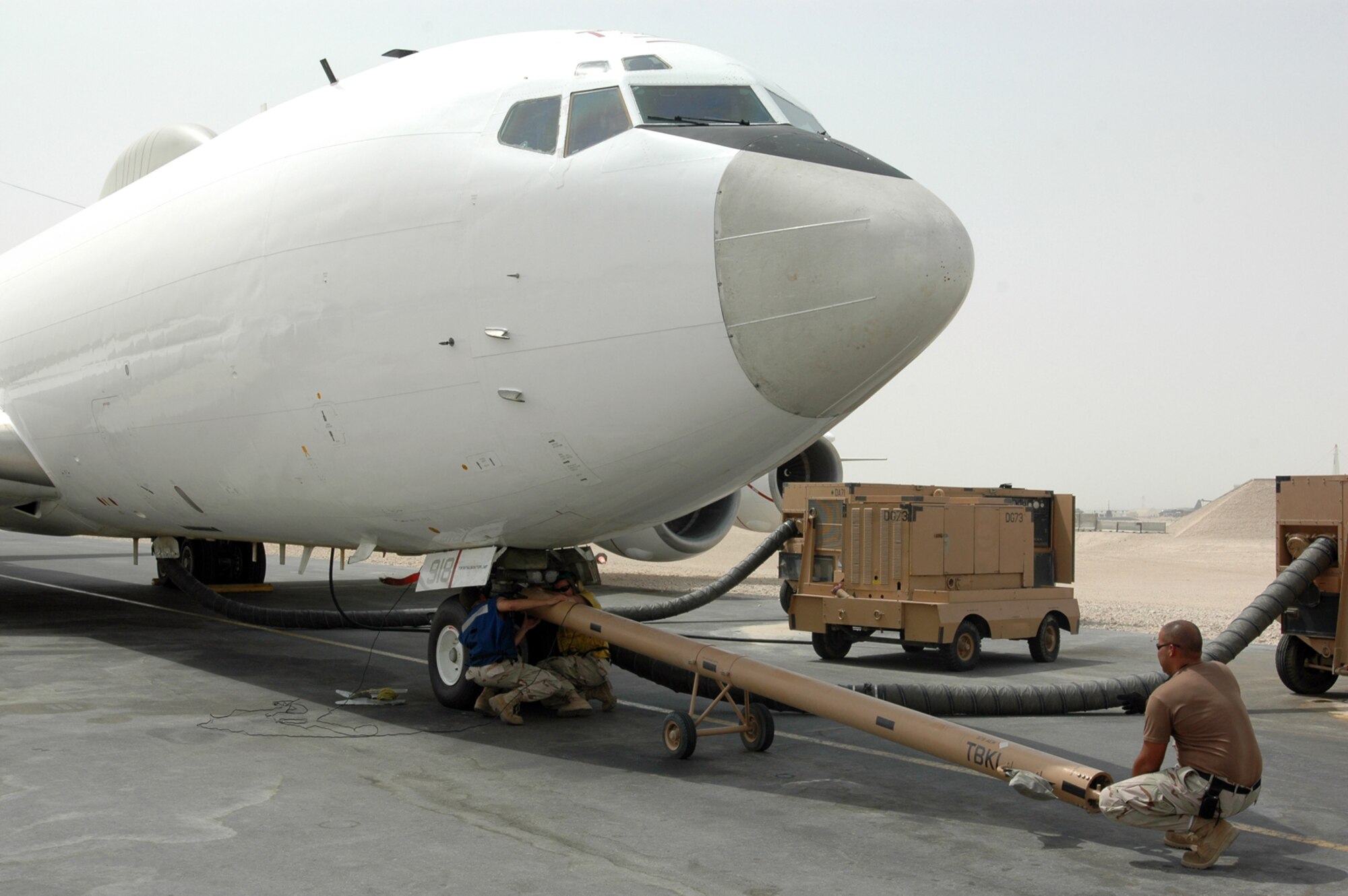 Navy Sailors with Task Force-124 prepare to move TACAMO aircraft onto a taxiway here. The aircraft helps relay communications for Soldiers on the ground  in Iraq.  (U.S. Air Force photo by Senior Airman Clark Staehle)