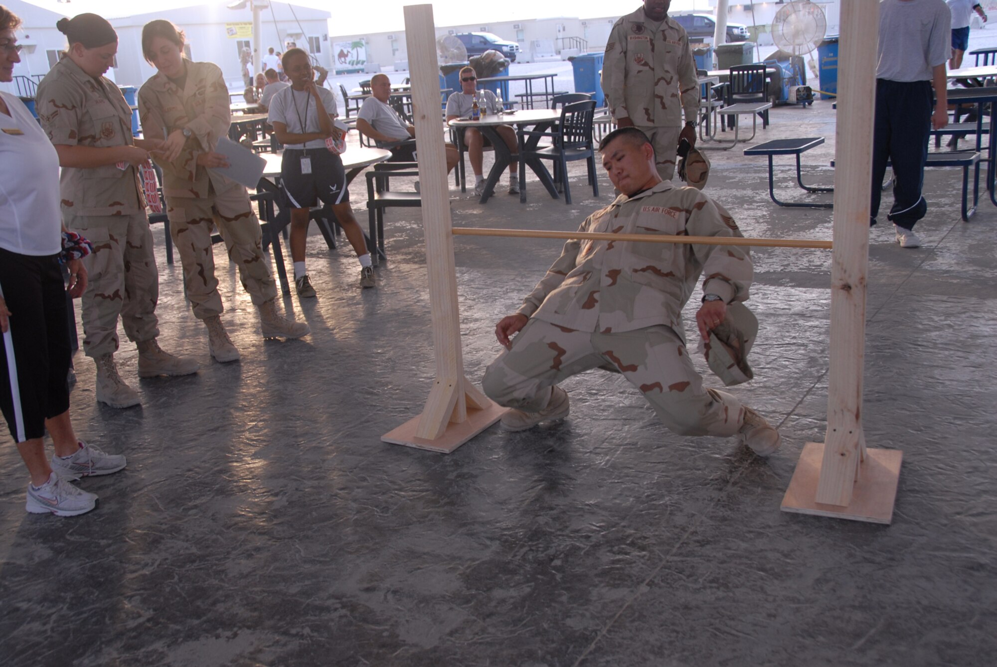 An Airman gets low during a limbo competition at Memorial Plaza. (U.S. Air Force photo by Airman 1st Class Ashley Tyler)